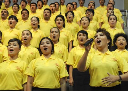 People perform a song named "I love you, China" during a celebration to greet the coming 60th anniversary of the founding of the People Republic of China in Urumqi, capital of northwest China's Xinjiang Uygur Autonomous Region on Aug. 27, 2009. Local people prepared many celebrations to greet the comming National Day of China which falls on Oct. 1st. (Xinhua/Wang Fei)