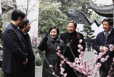 Madame Chou Kung-shin (C), director of Taiwan's world-renowned "National Palace Museum", enjoys the delicate miniature landscape during her visit to the Yuyuan Garden, in east China's Shanghai municipality, Feb. 17, 2009. Chou Kung-shin and her entourage start a 3-day-trip to Shanghai, with a wide range of landmark architectures and sightseeing resorts, among them the Shanghai Urban Planning Exhibition Center, the Shanghai World Financial Center, and the construction site of the 2010 World Expo Shanghai venue, etc, high on her itinerary of this cosmopolitan oriental pearl.