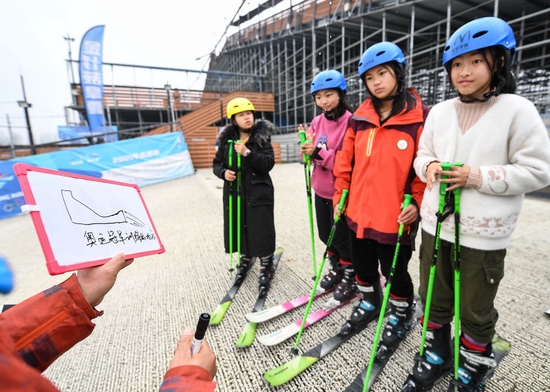 在成都市新都區尖鋒旱雪四季滑雪場，教練曹建用白板告訴小隊員蘇翊鳴、谷愛淩等奧運冠軍曾在這座滑雪場訓練（2月25日攝）。新華社記者 王曦 攝