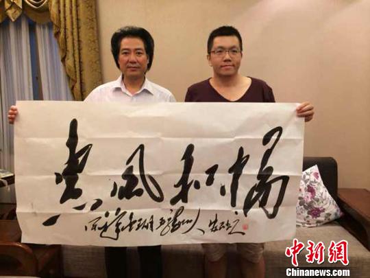     圖為著名毛體書法家安想珍（左）向臺灣著名畫家李炯毅贈送毛體書法作品　宋秀傑　攝