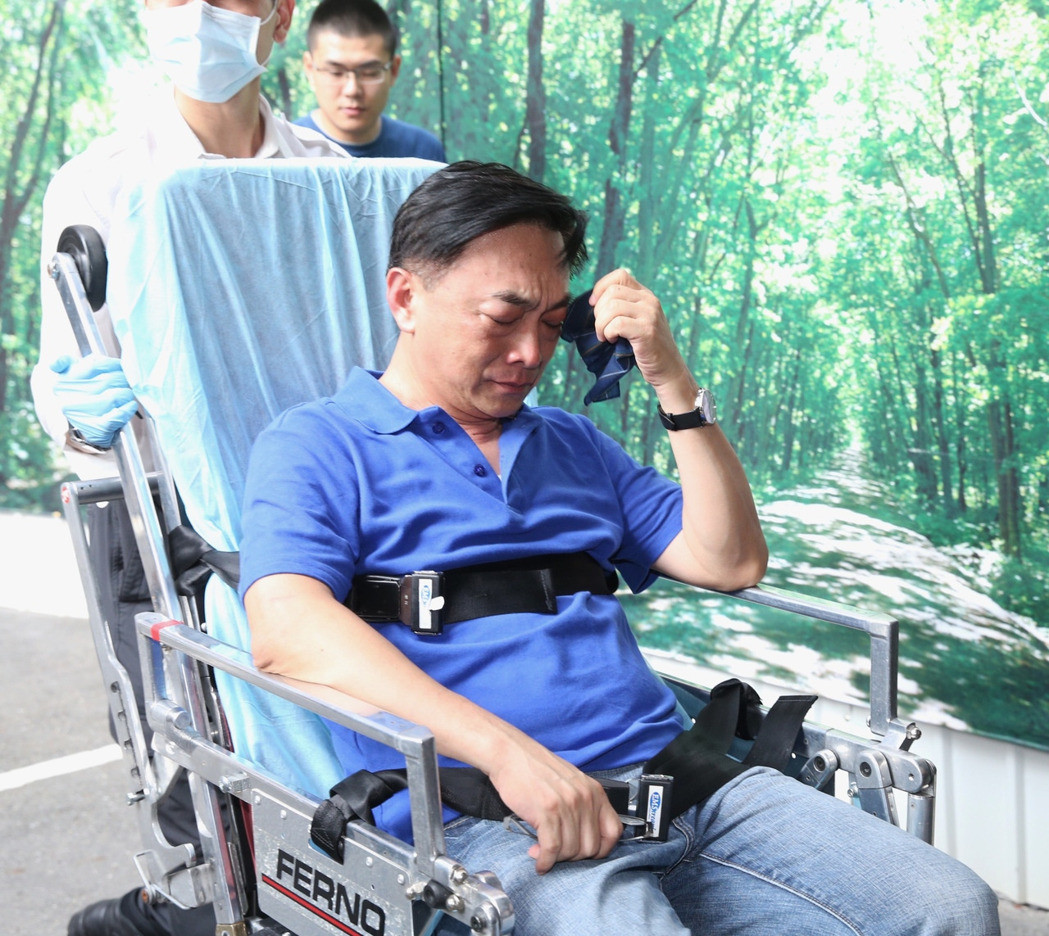 國民黨“立委”陳宜民受傷，坐在擔架上擦拭眼淚