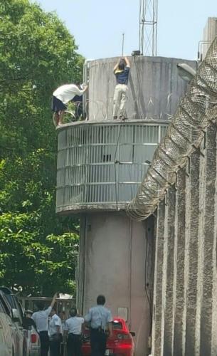 何姓男子(瞭望崗哨上白衣者)嫌獄中苦悶生活，異想天開逃獄，最後還是翻不出高墻。臺灣《聯合報》記者陳俊智／翻攝