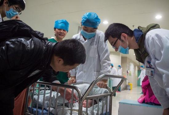 資料圖片：安徽醫科大學第一附屬醫院産房外，助産士將一個剛出生的嬰兒送到父親身邊。新華社記者 郭晨 攝